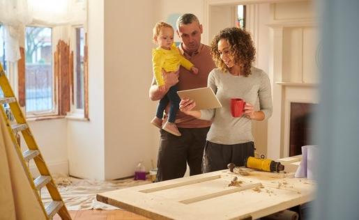 Couple with baby doing some renovations on their doors