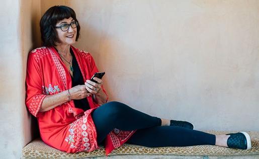 A woman with her phone sitting